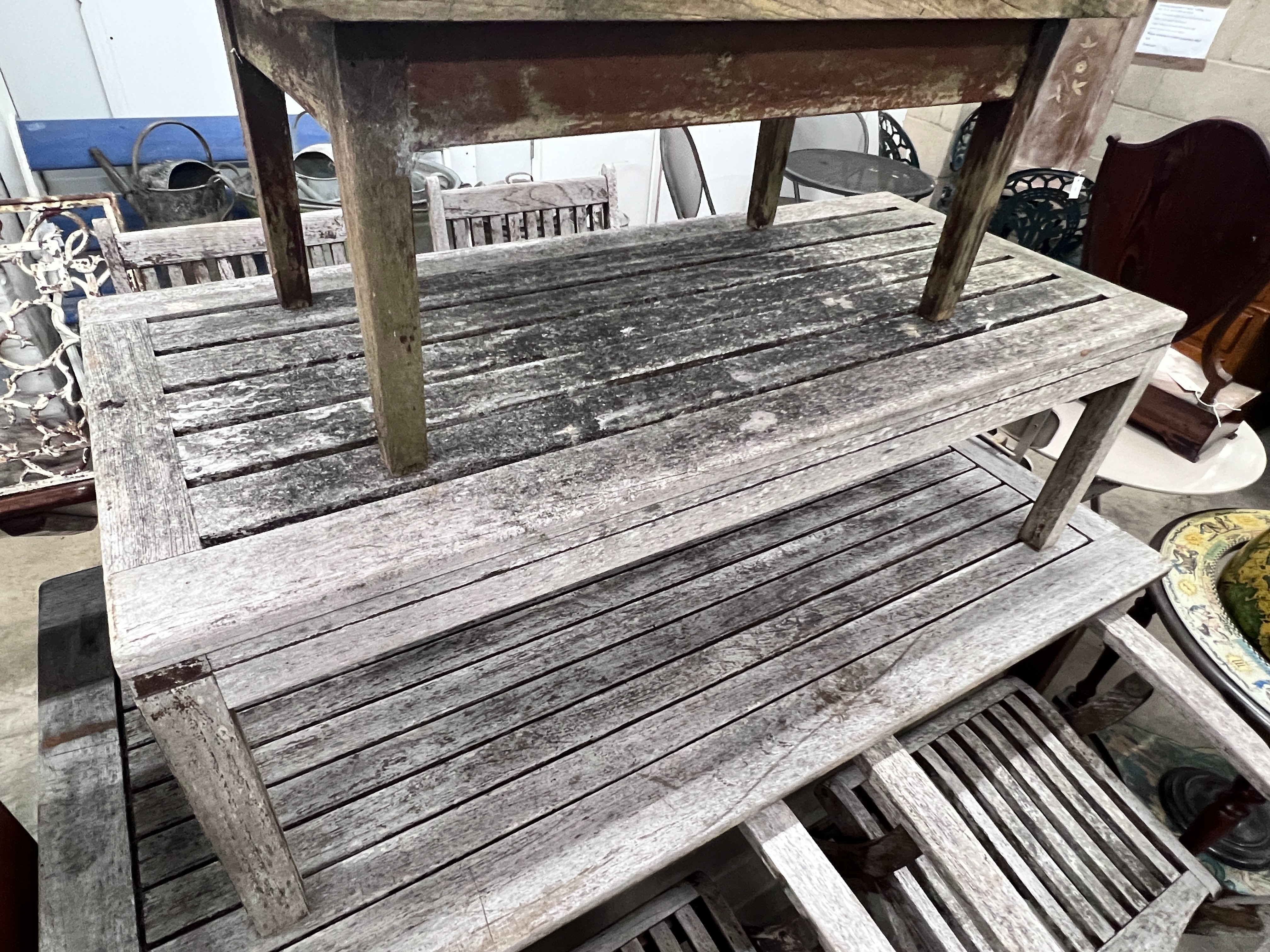 Four Westminster teak folding garden elbow chairs, Indian Ocean weathered teak rectangular garden table, length 151cm, depth 70cm, height 73cm and two low tables